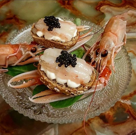 Crudo di scampi sopra una maionese di amaro Nonino e caviale
